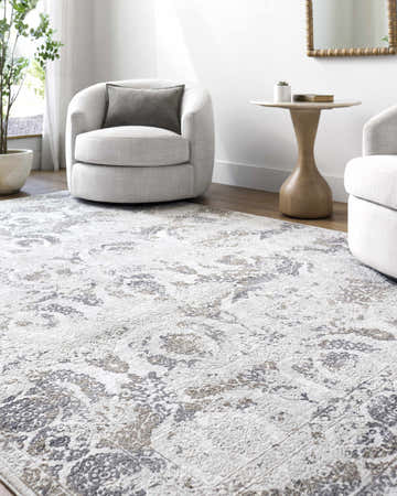 Living room scene with the Brigit Area Rug in cream, gray, and charcoal, paired with modern white swivel chairs and light wood accents. Roomscene-Rectangle