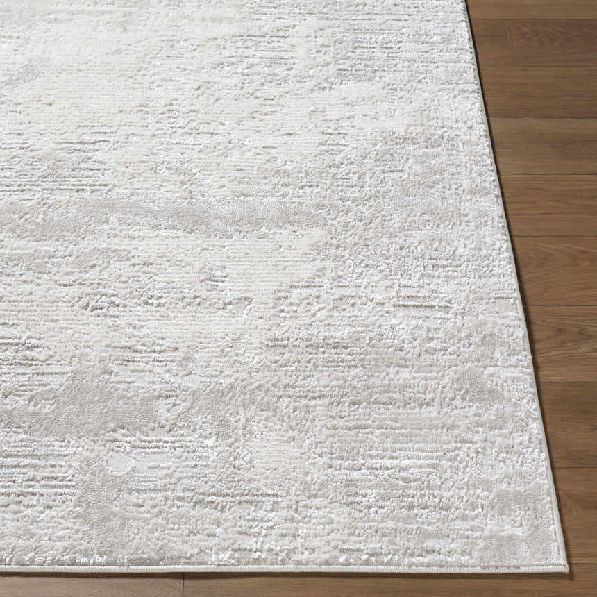 Close up of the Aramis Area Rug. Cream, ivory, light gray, and white tones with a subtle contemporary pattern. Front
