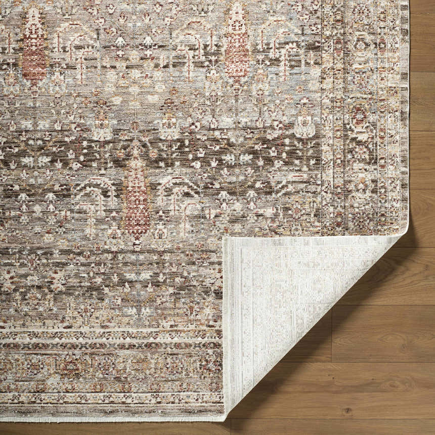 Close-up of the Brycen Area Rug showing its traditional cream, brown, and red pattern and machine-woven texture. Fold