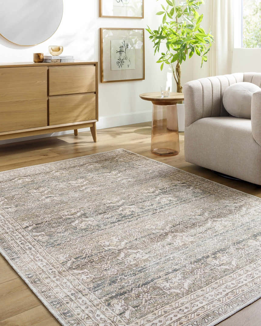 Living room scene with a cream Billie Vintage Flat Pile Washable Rug, light wood furniture, and neutral armchair. Roomscene-Rectangle