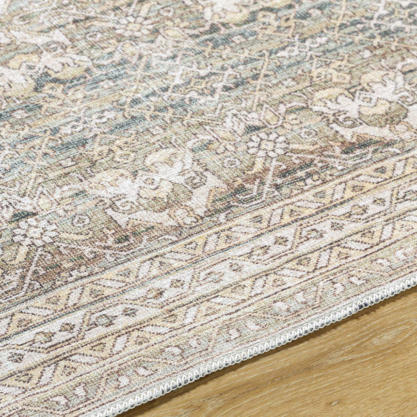 Close-up of Billie Vintage Flat Pile Washable Rug. Cream, green, and peach floral pattern with traditional border. Texture