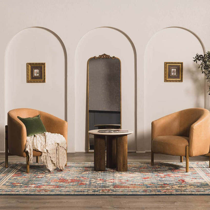 Living room scene with tan chairs and Neola Navy Blue Damask Area Rug in a traditional, bohemian style. Roomscene-Rectangle