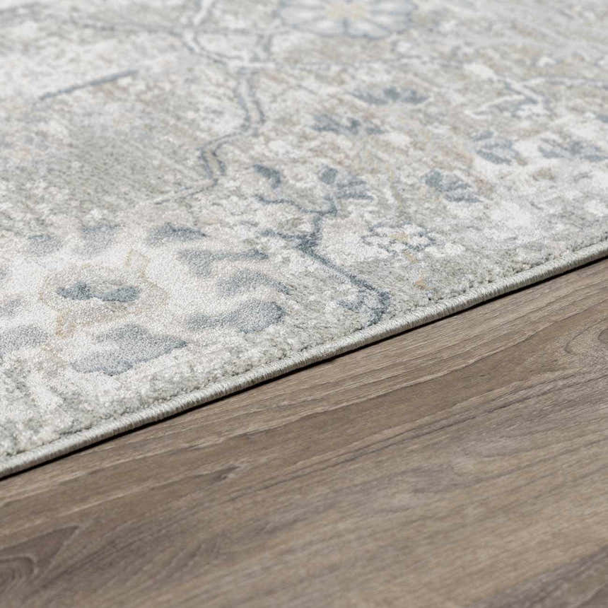Close-up of Barkisland Thick Luxe Oushak Rug showing its floral pattern and colors of light beige, sage and gray. Corner