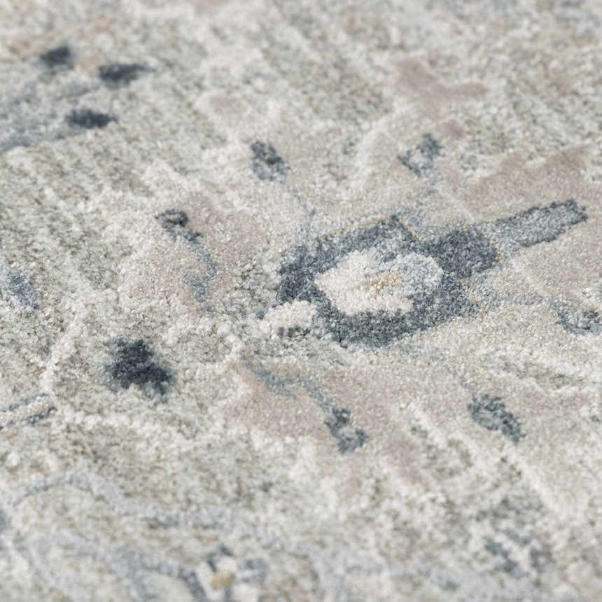 Close-up of the Barkisland Thick Luxe Oushak Rug. Features a traditional floral pattern in light beige, medium gray, and taupe. Texture