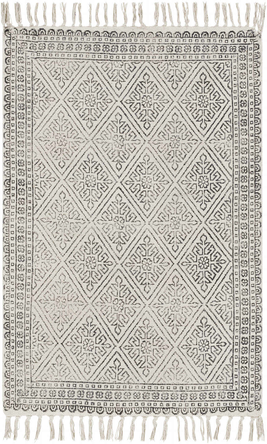 Close-up of the Brushton Area Rug. Beige cotton rug with a black geometric diamond pattern and tassels. Hand woven. Design-Rectangle-23
