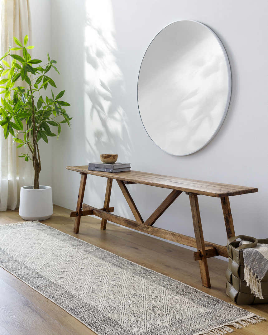 Entryway with Brushton Area Rug runner, wood bench, round mirror, and potted plant for a bright, contemporary look. Roomscene-Runner
