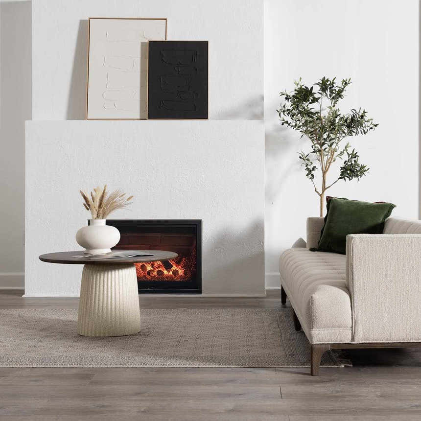 Living room scene with beige Brushton Area Rug, fireplace, modern art, and neutral sofa. Roomscene-Rectangle