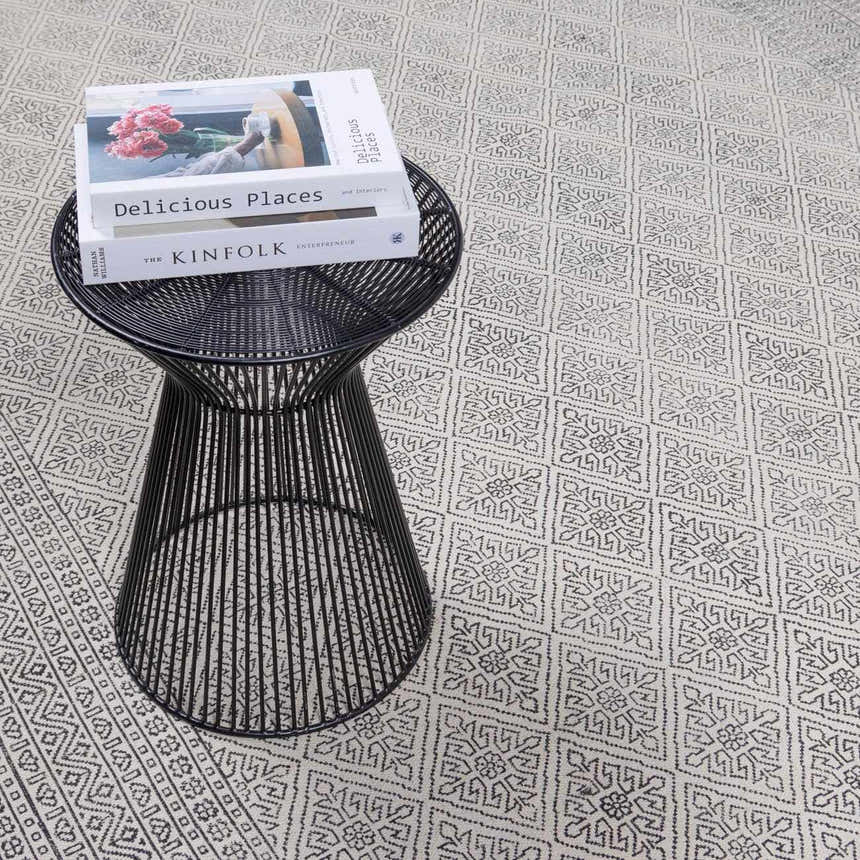 Close-up of the beige and black geometric pattern on the hand woven cotton Brushton Area Rug. Styleshot