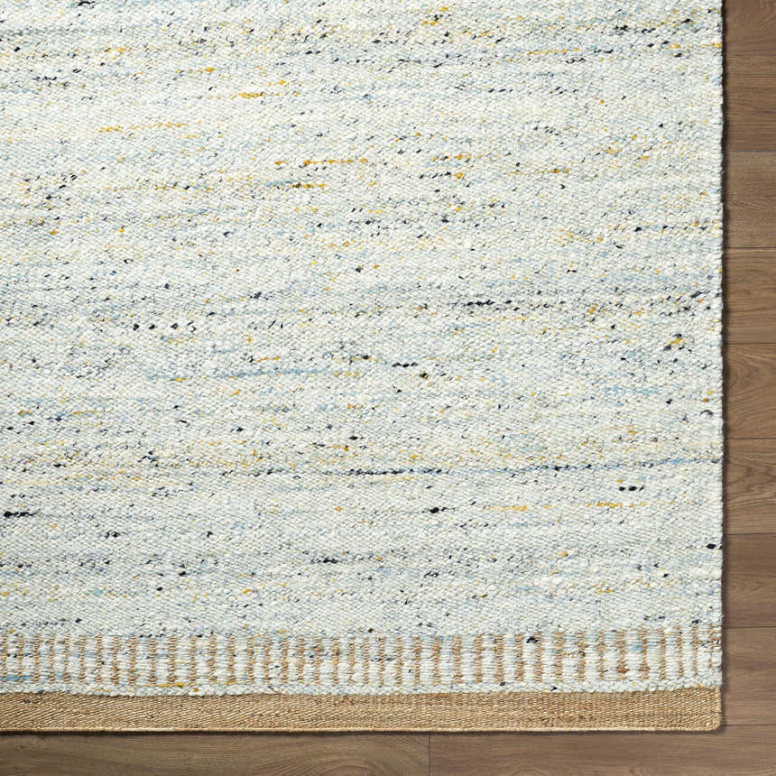 Close-up of the hand-woven Andrey Dark Beige Area Rug showing charcoal, light brown, and medium brown wool texture. Corner