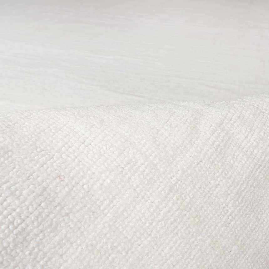 Close-up of the white Brownsdale Area Rug showing its hand-loomed texture and subtle striped pattern. Swatch