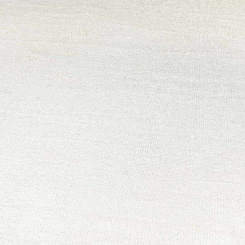 Close-up of the white, hand-loomed Brownsdale Area Rug, showing texture. Contemporary style, suitable for kids room. Texture