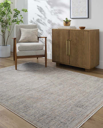 Living room scene with Galey Alix Maria Elena III Ivory Vintage Rug, accent chair, and wooden cabinet. Roomscene-Rectangle