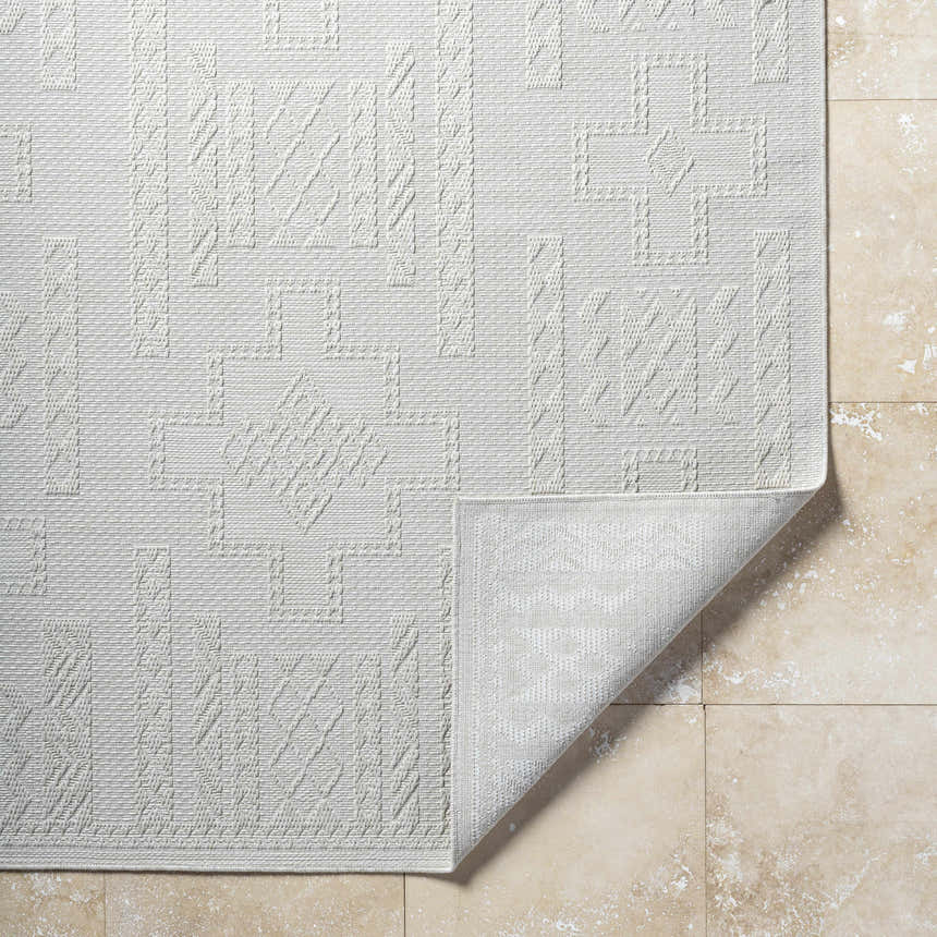 Close-up of the light silver Branko Area Rug, showcasing its contemporary geometric pattern and woven texture. Fold