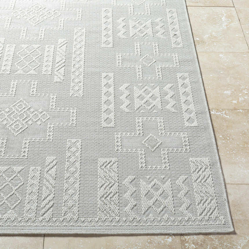 Close-up of the light silver Branko Area Rug featuring a contemporary geometric pattern and machine woven texture. Front