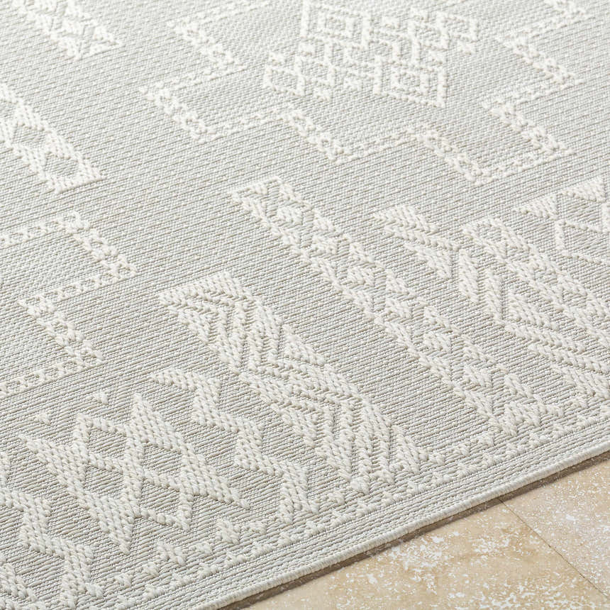 Close-up of the light silver Branko Area Rug, showcasing its contemporary geometric pattern and machine-woven texture. Texture