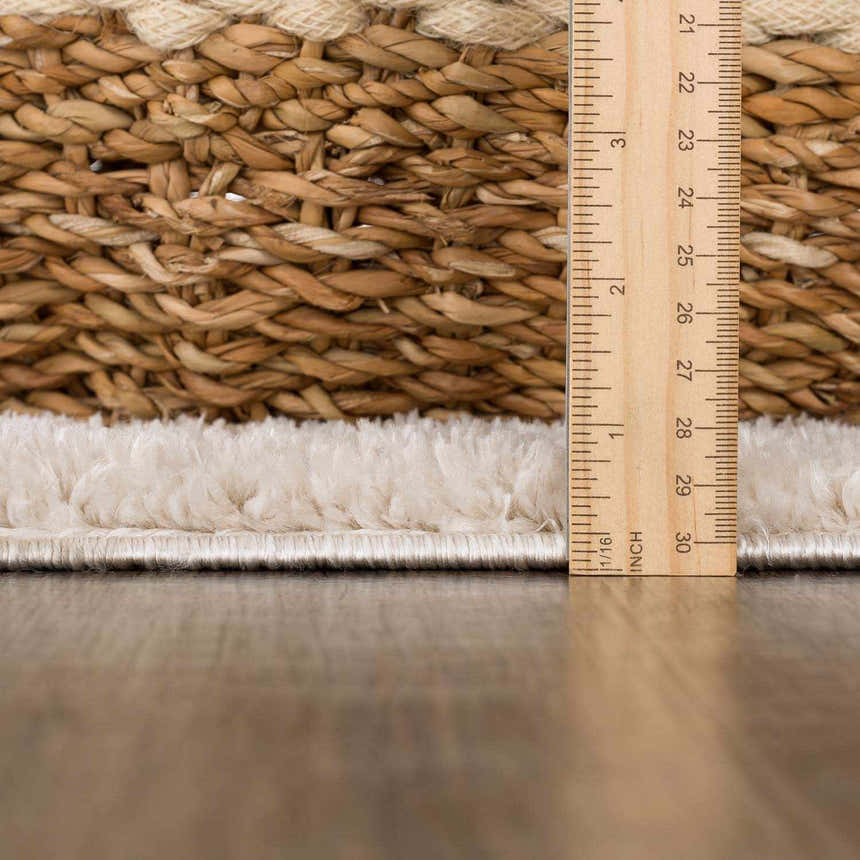 Close up of the Beynon Beige Washable Area Rug showing its texture, pile height, and woven construction. Pile