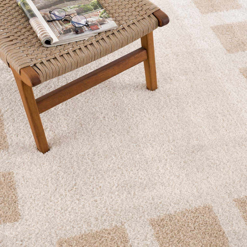 Close-up of the Beynon Beige Washable Area Rug showing its plush texture and geometric beige and cream pattern. Styleshot