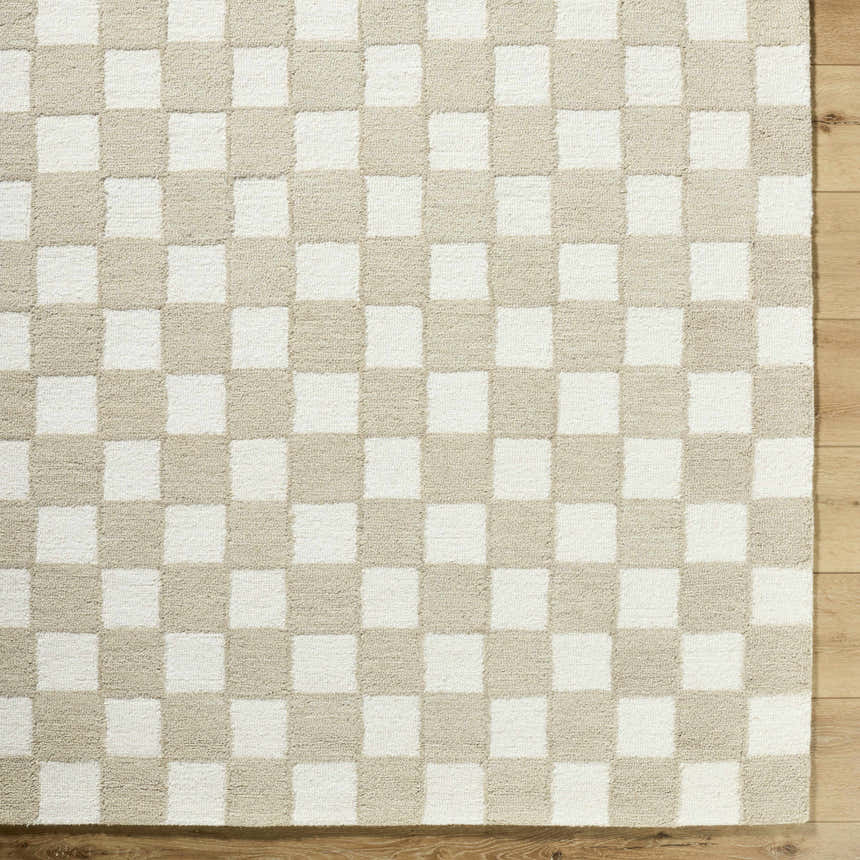 Close-up of the Amparo Beige Area Rug. Hand-tufted wool rug with a beige and ivory checkerboard pattern. Corner