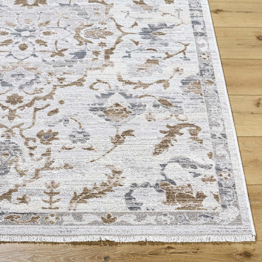 Close-up of the Aldona Area Rug showing its farmhouse design, charcoal, ivory, slate gray, and taupe colors. Front