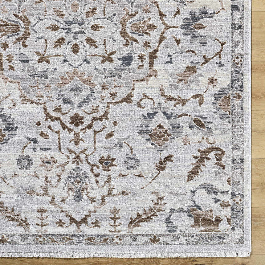 Close-up of the Aldona Area Rug, a machine-woven design in charcoal, ivory, slate gray, and taupe polyester. Farmhouse style. Swatch