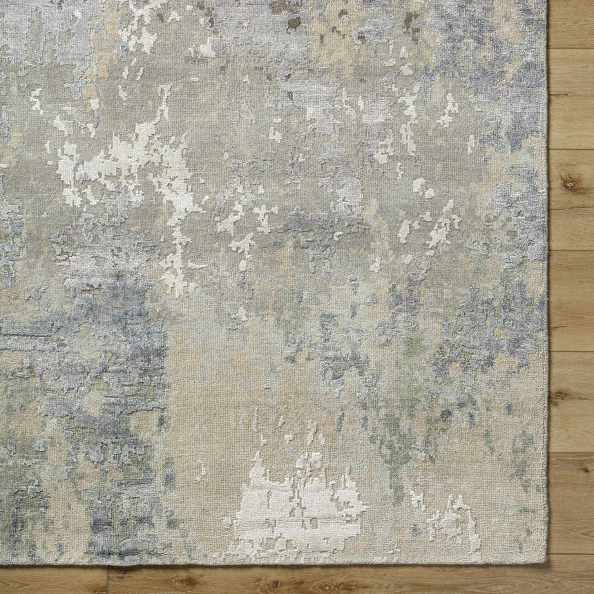 Close-up of the Bued Handmade Wool-Blend Rug. Abstract design in beige, brown, gray, teal, and ivory on a textured wool blend. Swatch