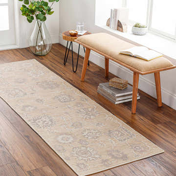 Hallway scene with a beige and gray Bulusan Premium Rug runner, wood floors, and a bench by the window. Roomscene-Runner
