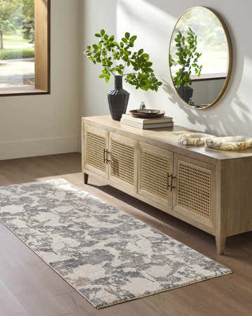 Entryway with a Breeda Cream runner rug, wood console table, round mirror, and hardwood floors. Roomscene-Runner