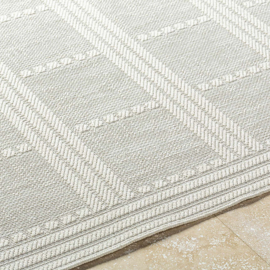 Close up of the light silver Bahari Area Rug showing the woven texture and farmhouse style pattern. Texture
