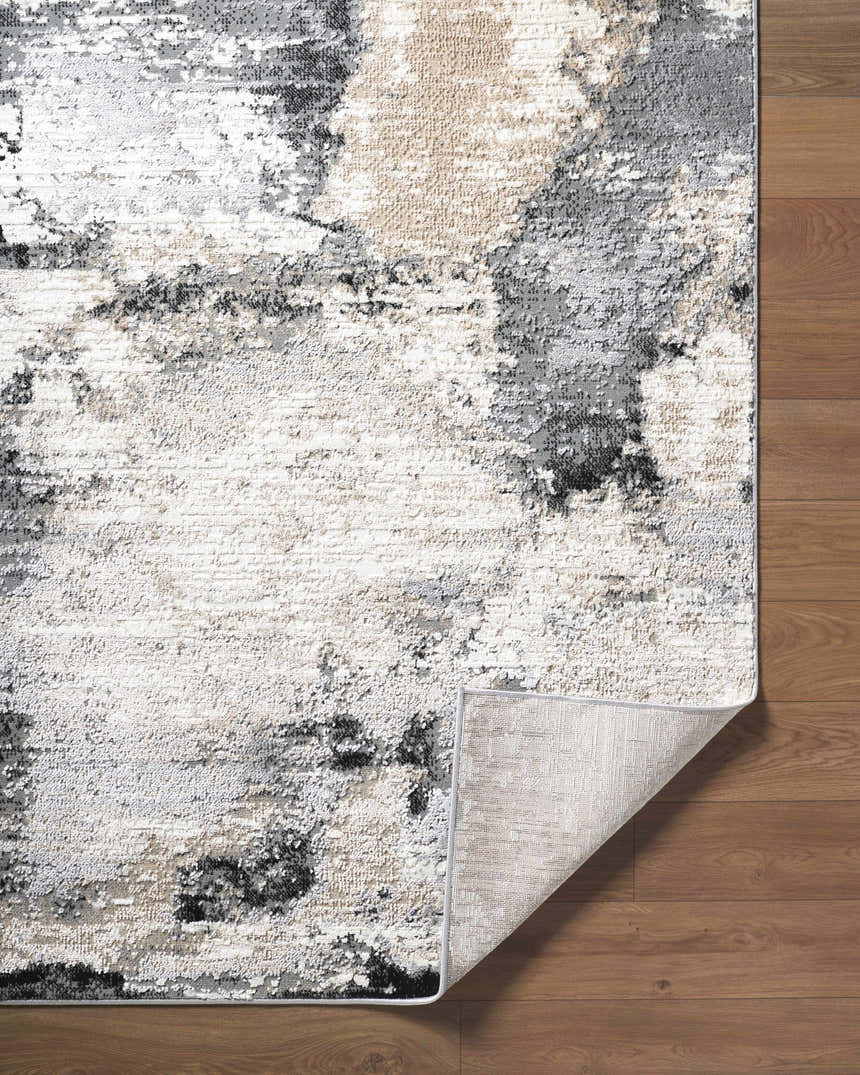 Close-up of the Birdie Area Rug showing ash, light silver, sage, and silver gray tones and machine woven texture. Fold