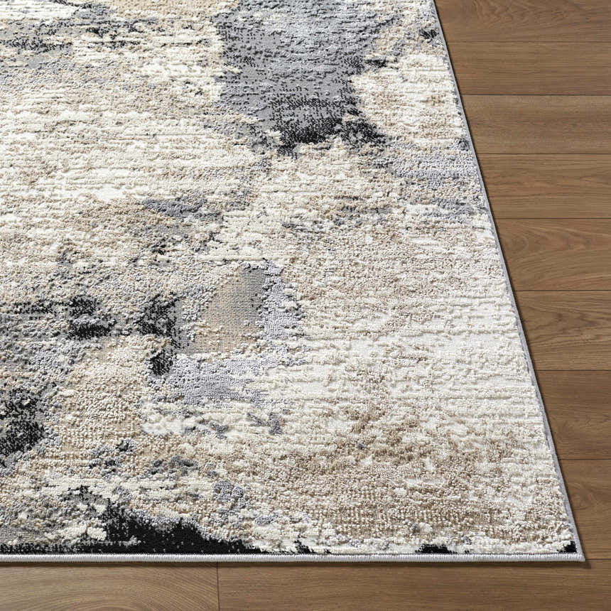 Close-up of the Birdie Area Rug showing its ash, silver gray, and sage abstract pattern and soft, textured pile. Front