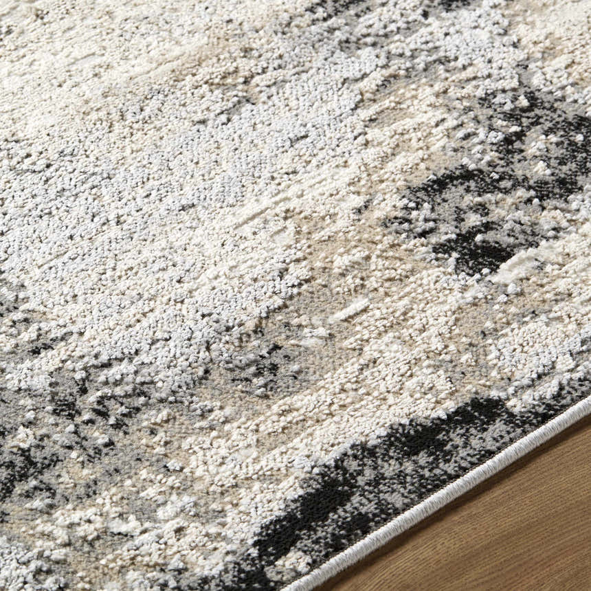 Close-up of the Birdie Area Rug. Ash, light silver, sage, and silver gray tones with a textured, contemporary design. Texture