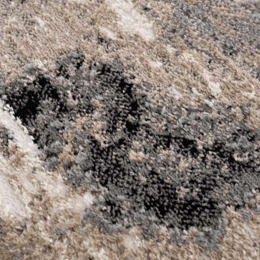 Close-up of the Birdie Area Rug showing its ash, light silver, sage, and silver gray colors and soft, textured weave. Texture