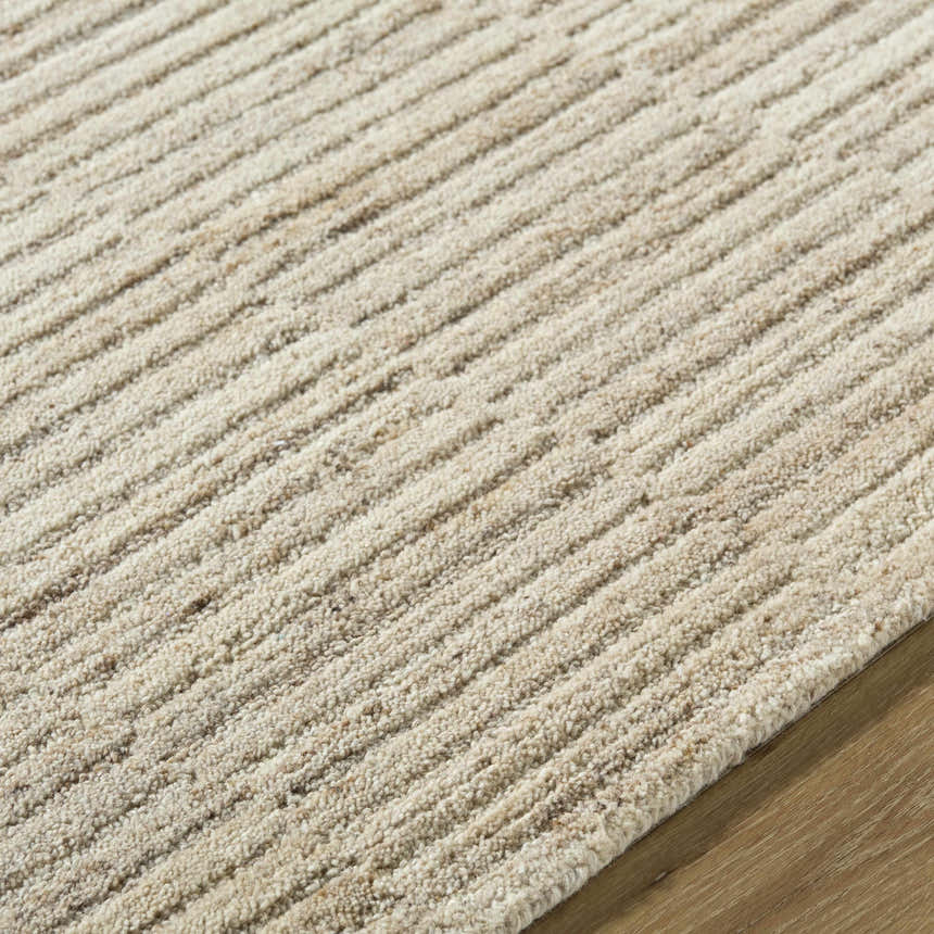 Close up of the Andred Tan Area Rug. Beige and tan wool rug with a textured, ridged design. Farmhouse style. Texture