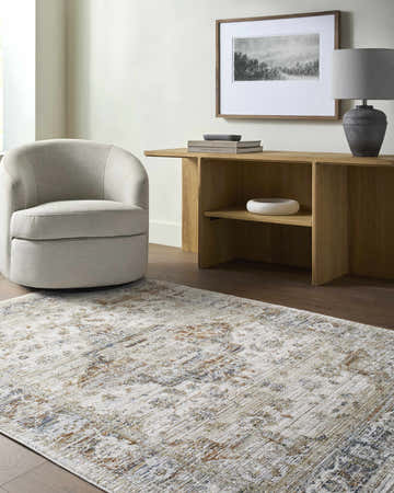 Living room scene with a neutral swivel chair and wood console table on a Cargan Area Rug. Roomscene-Rectangle
