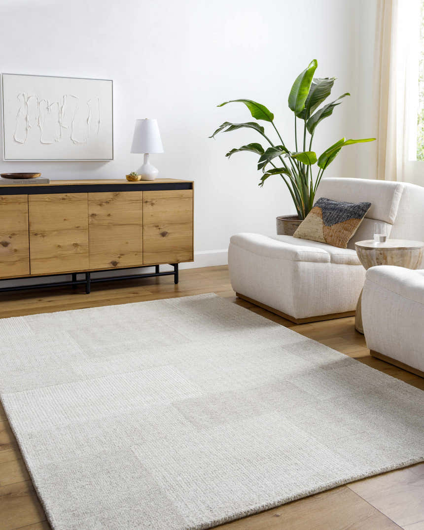 Living room with beige Camila Area Rug, wood console, and cream armchairs creating a neutral, modern space. Roomscene-Rectangle