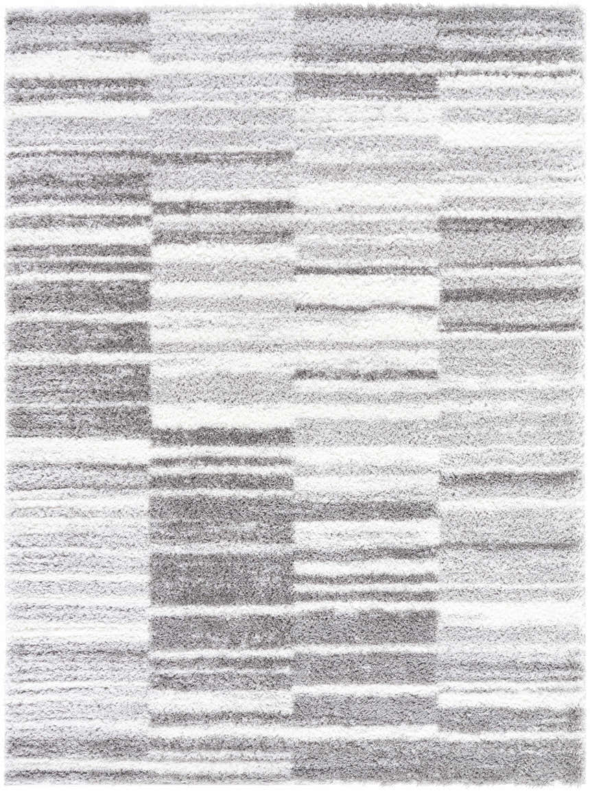 Close-up of the Carlen Gray Area Rug, a shag rug with a contemporary gray, ivory, and light gray striped pattern. Design-Rectangle-537