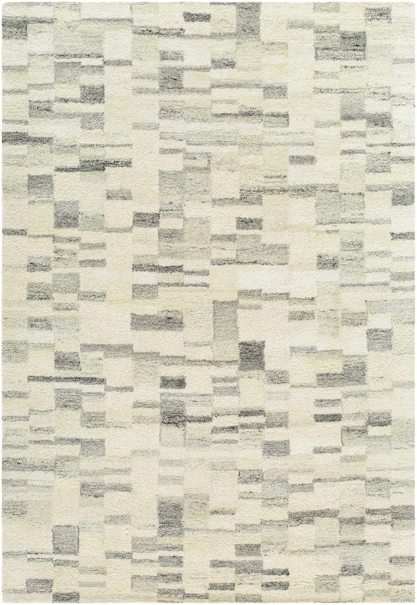 Close-up of the Max Handmade Becki Owens x LIVABLISS rug. Hand-tufted wool rug in blue, charcoal, dove gray, and ivory. Contemporary style. Design-Rectangle-576