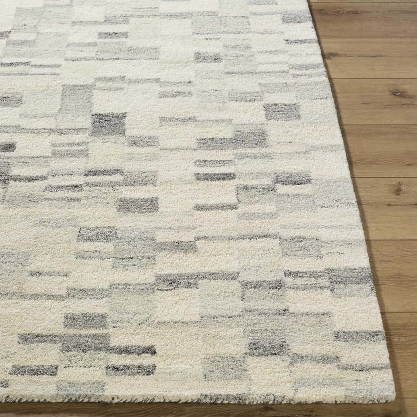Close-up of the Max Handmade Becki Owens x LIVABLISS Area Rug. Ivory wool rug with a contemporary blue and gray geometric pattern. Front