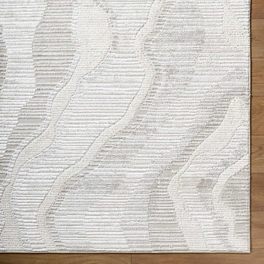 Close-up of the Aniela Area Rug. Contemporary design with cream, ivory, and gray tones. Textured, machine-woven rug. Corner