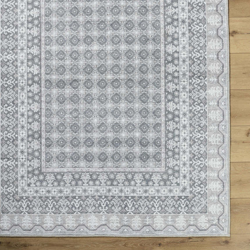 Close-up of the Rainier Gray Washable Rug. Farmhouse style rug with off-white, pale blue, sage, and tan traditional pattern. Swatch