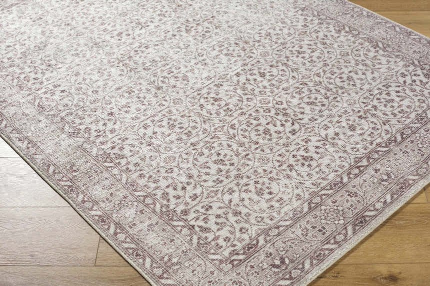 Close-up of the Spokane Brown Area Rug, showcasing its traditional floral pattern in cream, tan, and brown tones. Corner