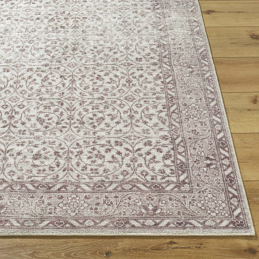 Close-up of the Spokane Brown Area Rug. Traditional floral pattern in burnt orange, cream, and tan on wood floor. Front