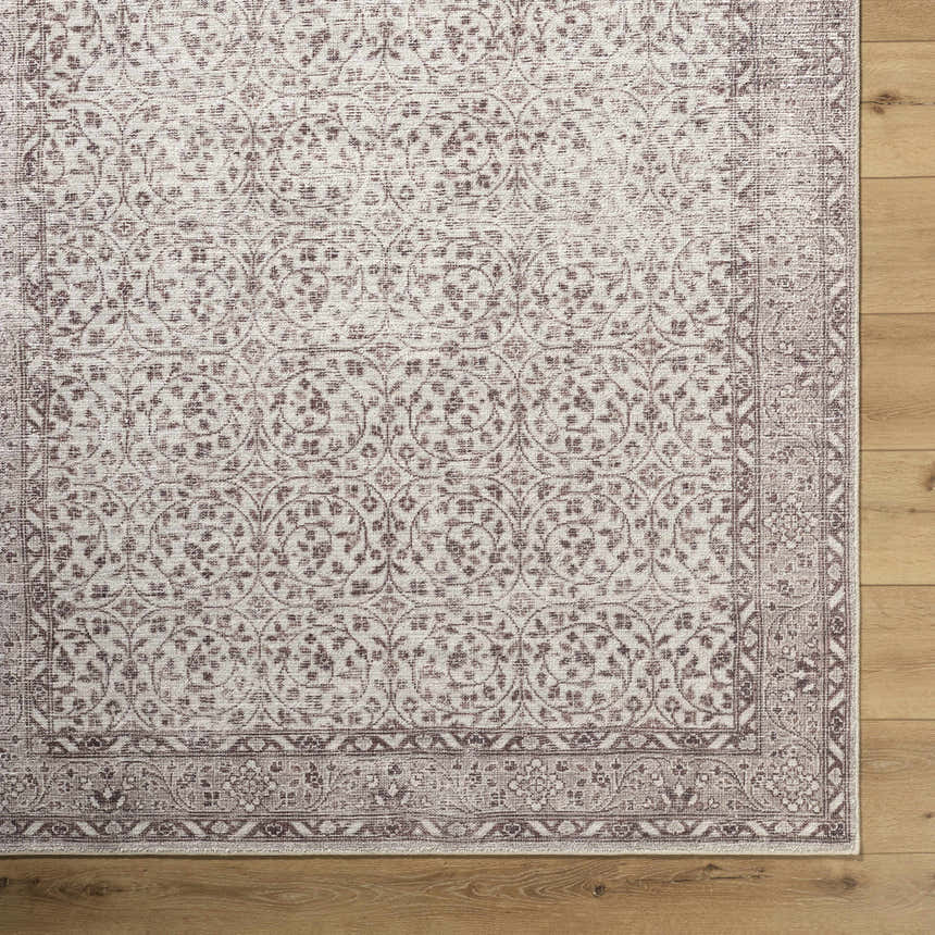 Close-up of the Spokane Brown Area Rug, featuring a traditional floral pattern in cream and medium brown on a wood floor. Corner