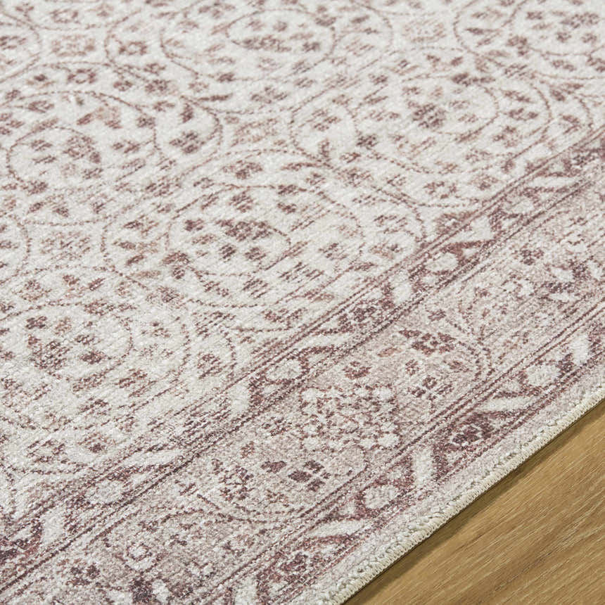 Close-up of the Spokane Brown Area Rug. Farmhouse style with a cream and burnt orange traditional pattern. Texture