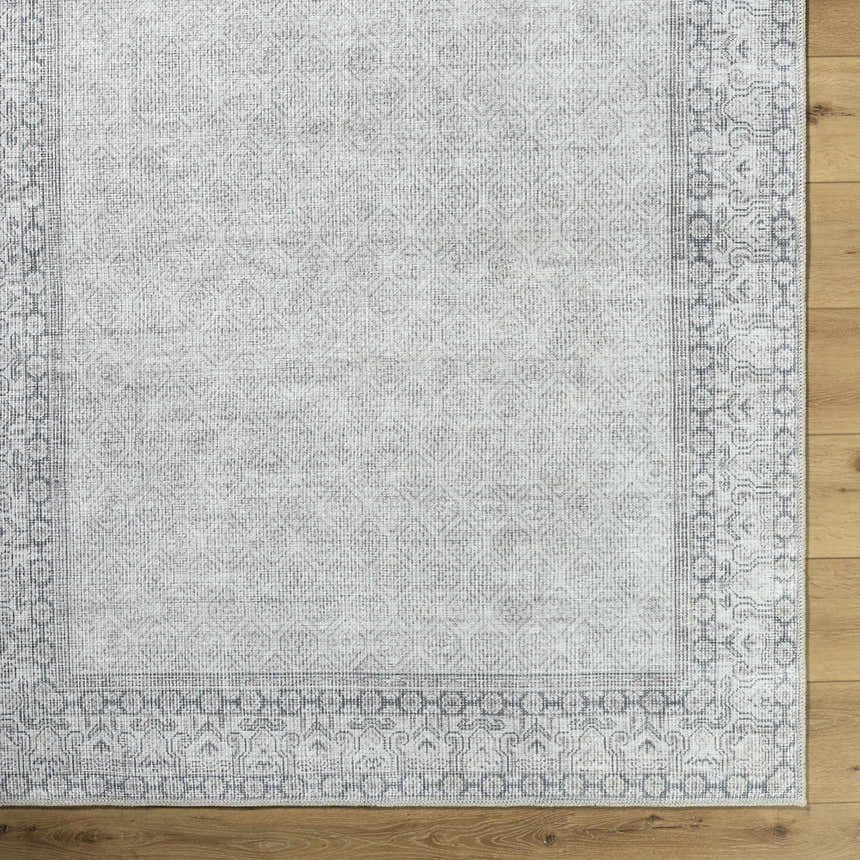 Close-up of Rainier Cottage Border Gray Washable Rug showing farmhouse style pattern and gray, off-white colors. Corner