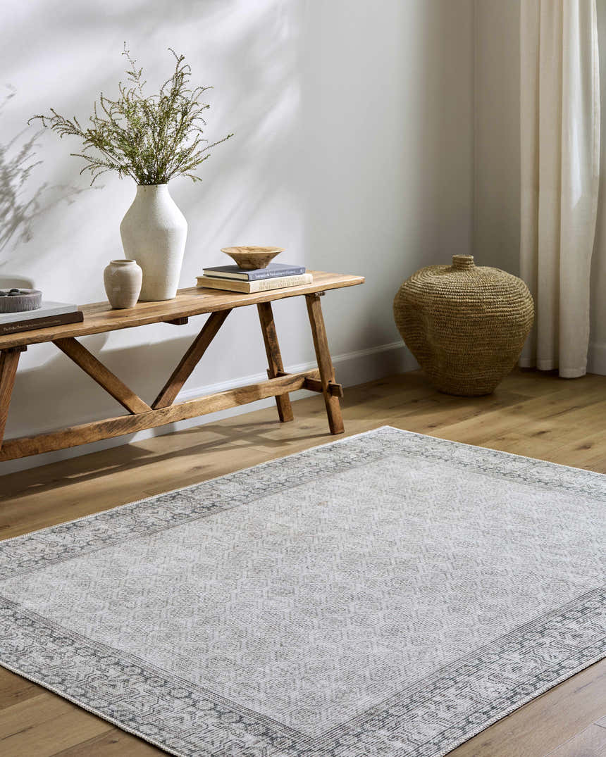 Entryway with Rainier Cottage Border Gray Washable Rug, wood bench, vases, books, and woven basket. Farmhouse style. Roomscene-Rectangle