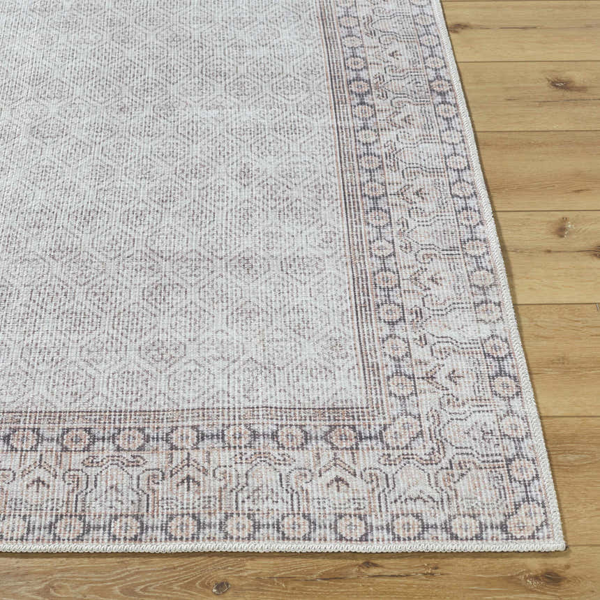 Close-up of Rainier Cottage Border Beige Washable Rug showing farmhouse style pattern and charcoal, cream, and tan colors. Front