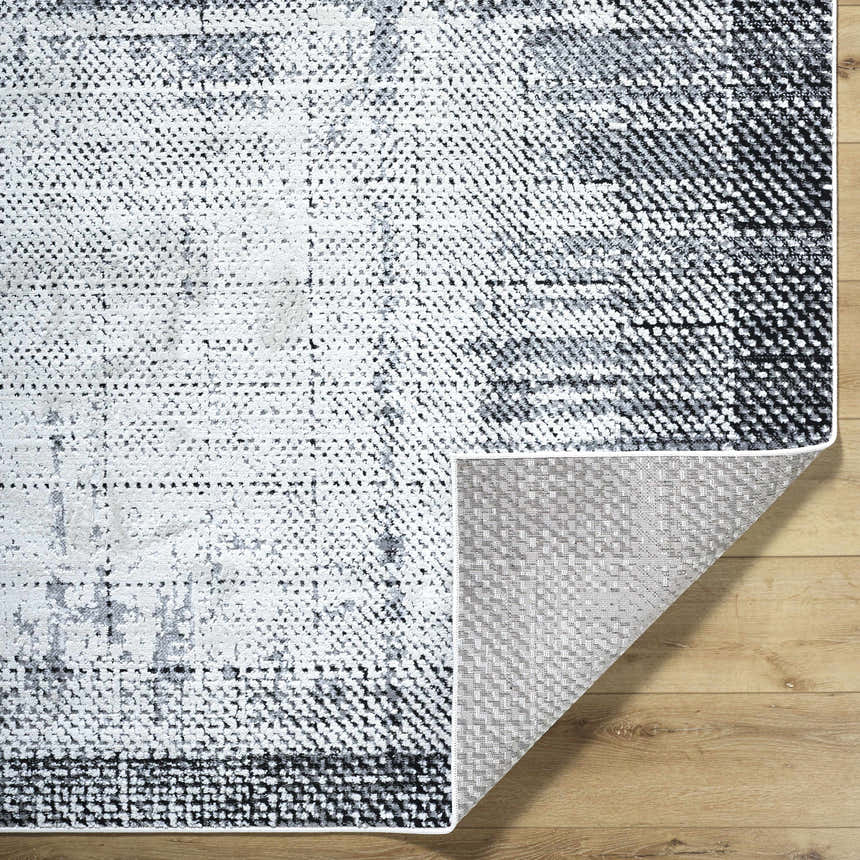 Close-up of the Colson Gray Area Rug showing its light silver, onyx, and silver gray contemporary design. Fold