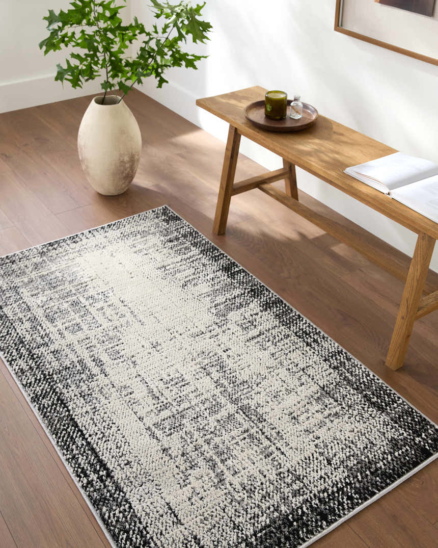 Minimalist entryway with a Colson Gray Area Rug, wooden bench, vase, and wood floors. Roomscene-Runner