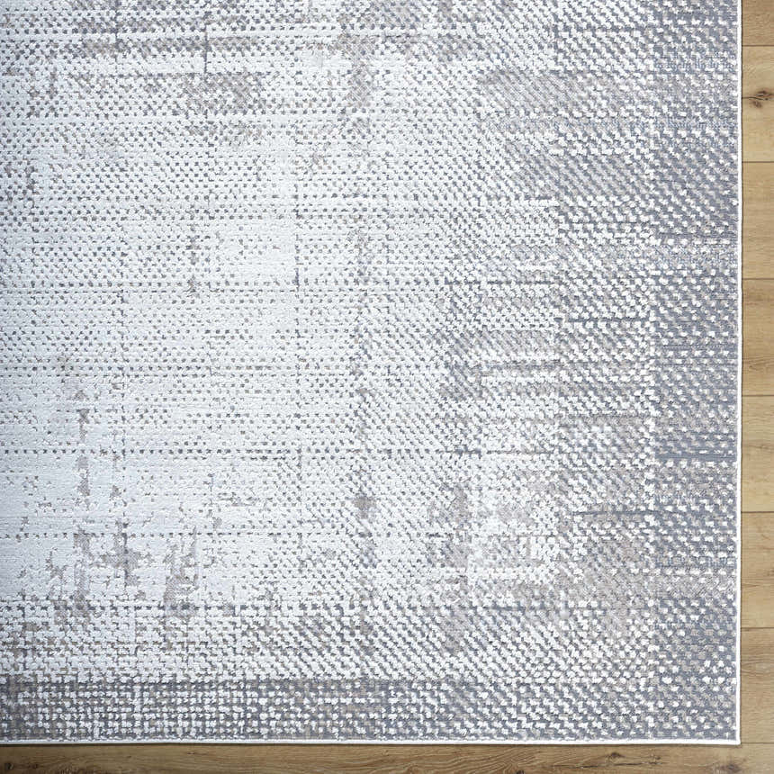 Close up of Colson Sage Area Rug, a contemporary rug with ash, silver gray, and slate blue tones. Corner